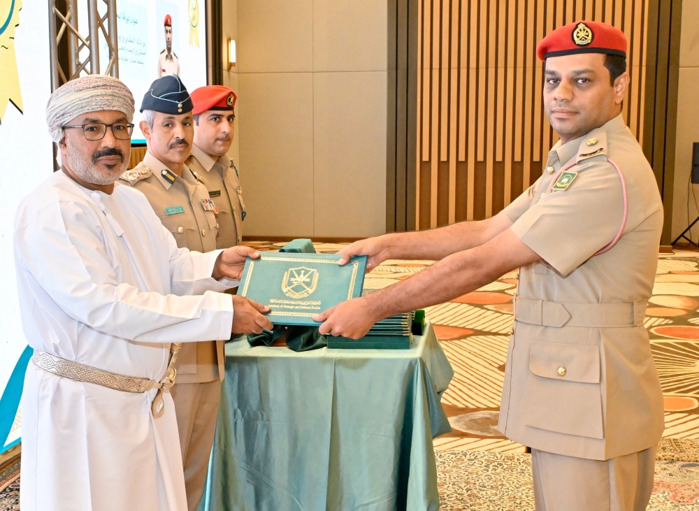 An officer receives his award at the concluding ceremony of the Ministry of Defence Research Paper Competition. — ONA
