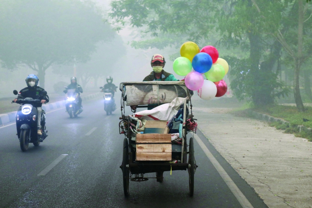 Motorists commute in the afternoon in Palangkaraya, Central Kalimantan. — AFP