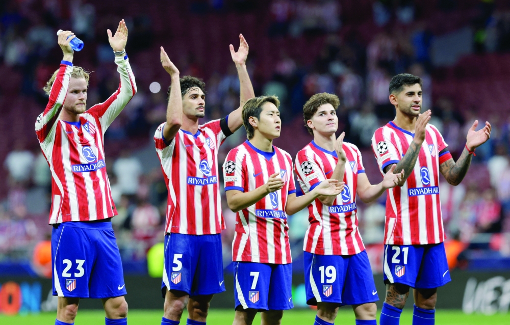 Atletico Madrid players applaud fans after the Uefa Champions League match against Manchester United in Madrid. — Reuters