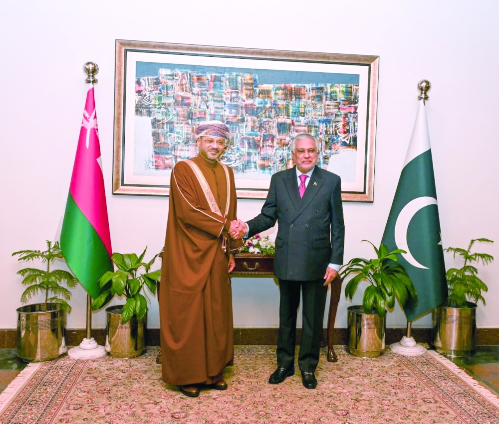 Sayyid Badr bin Hamad al Busaidi, Foreign Minister, shakes hands with Mohammad Ishaq Dar, Deputy Prime Minister and Minister of Foreign Affairs of Pakistan, in Islamabad. — ONA
