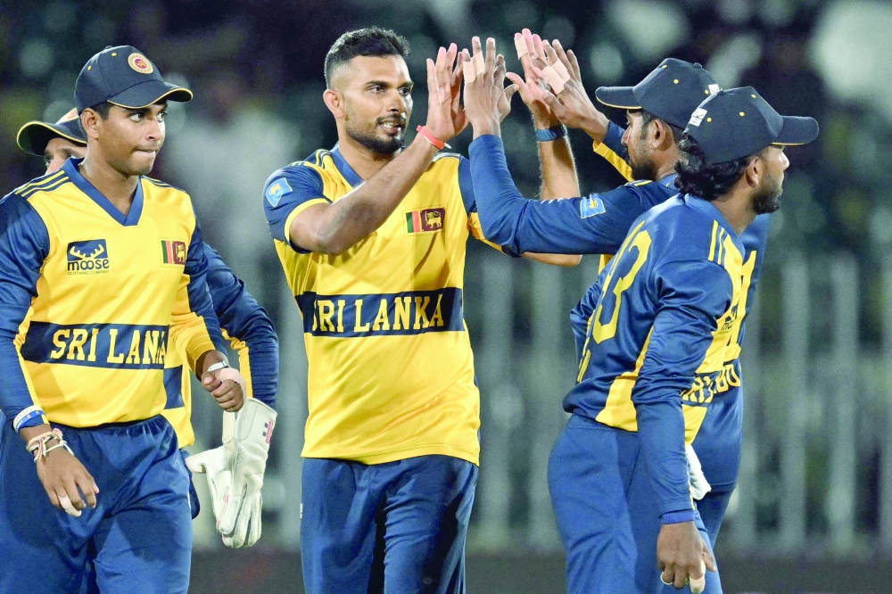 Sri Lanka's Dasun Shanaka (2L) celebrates with teammates after taking the wicket of Pakistan's Khawaja Nafay during the third T20 international cricket match between Pakistan and Sri Lanka at the Rawalpindi Cricket Stadium in Rawalpindi on October 13, 2026. (Photo by FAROOQ NAEEM / AFP)
