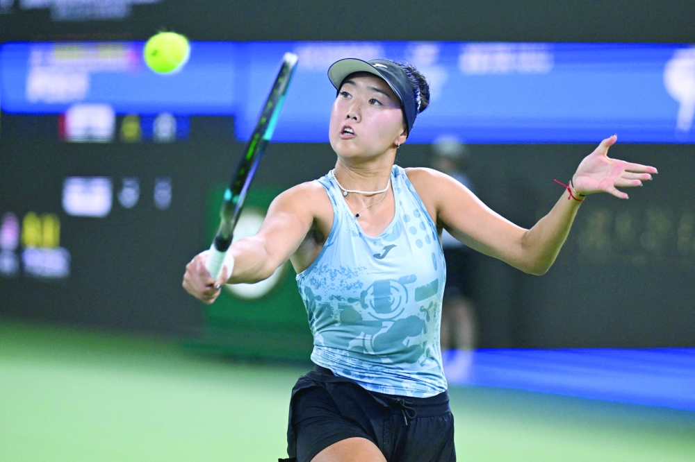 USA's Ann Li hits a return to Belarus's Aryna Sabalenka during their women's singles match at the Wuhan Open tennis tournament in Wuhan, in China's Hubei province on October 14, 2026.  (Photo by WANG Zhao / AFP)
