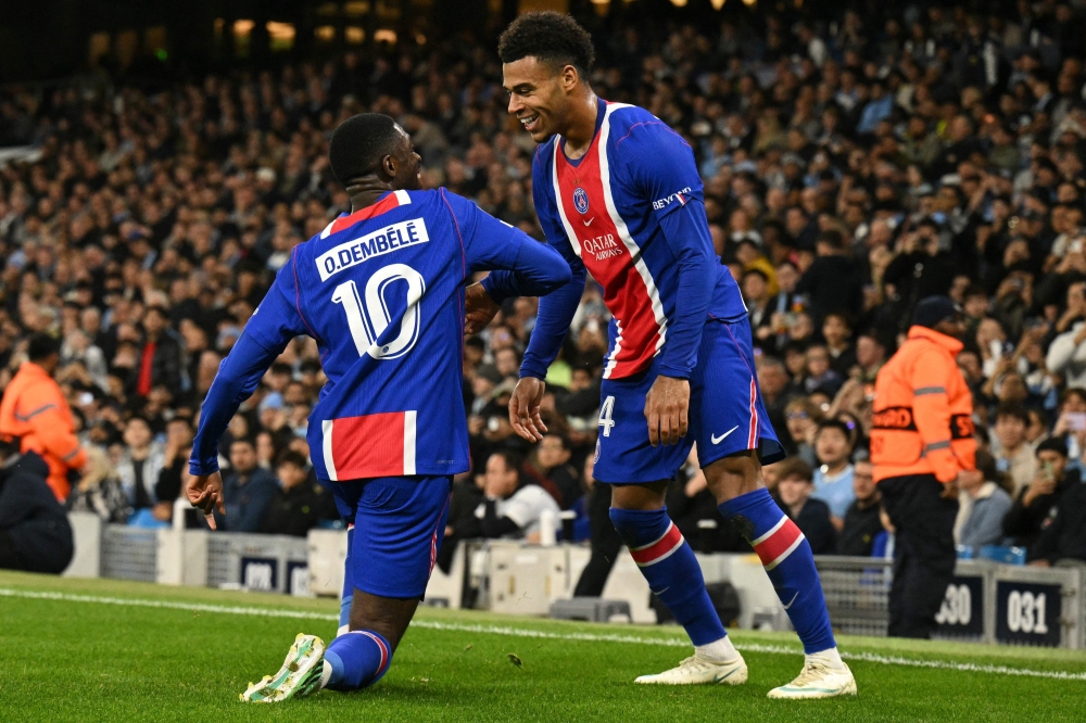 French striker #10 Ousmane Dembele (L) celebrates with  French midfielder #14 Desire Doue (R) after scoring their second goal 