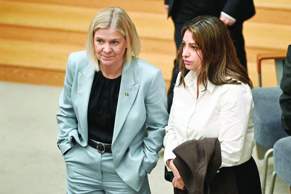 Social Democrats leader Magdalena Andersson (left) speaks with Left Party leader Nooshi Dadgostar in parliament in Stockholm on Thursday. — AFP