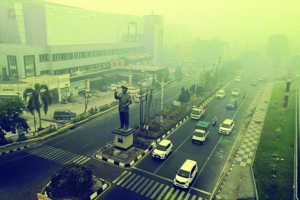 An aerial view shows thick smoke and haze from forest and land fires over Palangkaraya, Central Kalimantan, on Thursday. — AFP