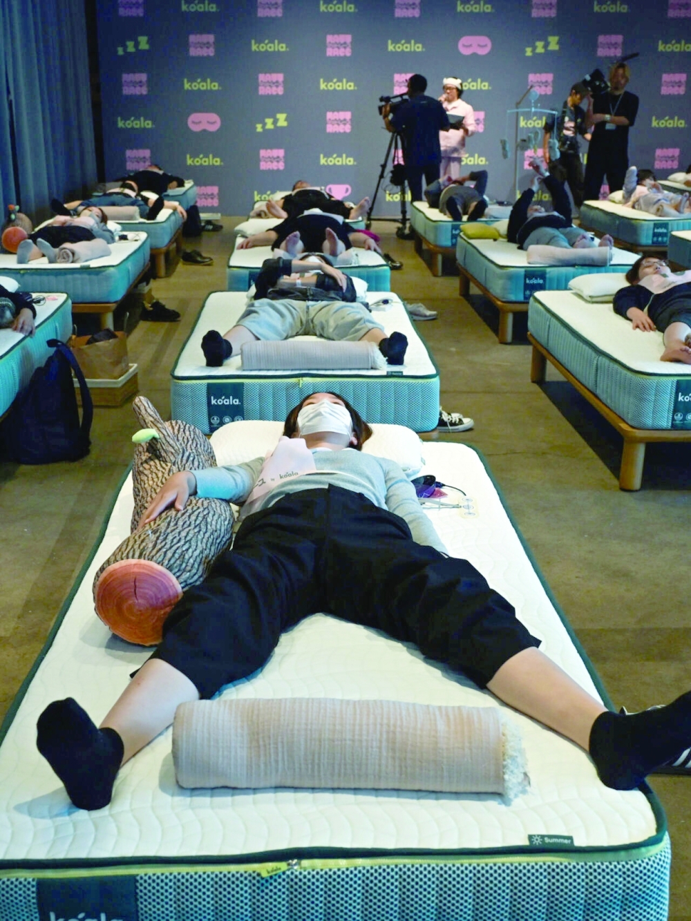 Participants compete in Tokyo’s “Matt Race” sleeping competition.