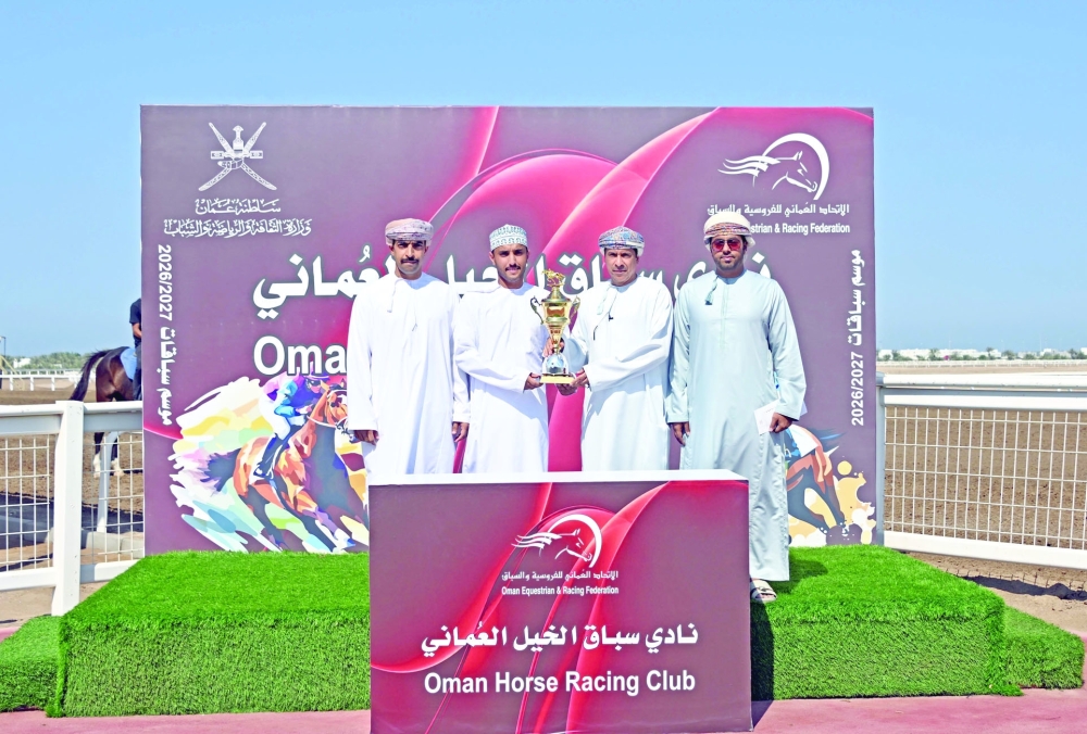A winner being presented with the trophy.  — Mohammed al Balushi