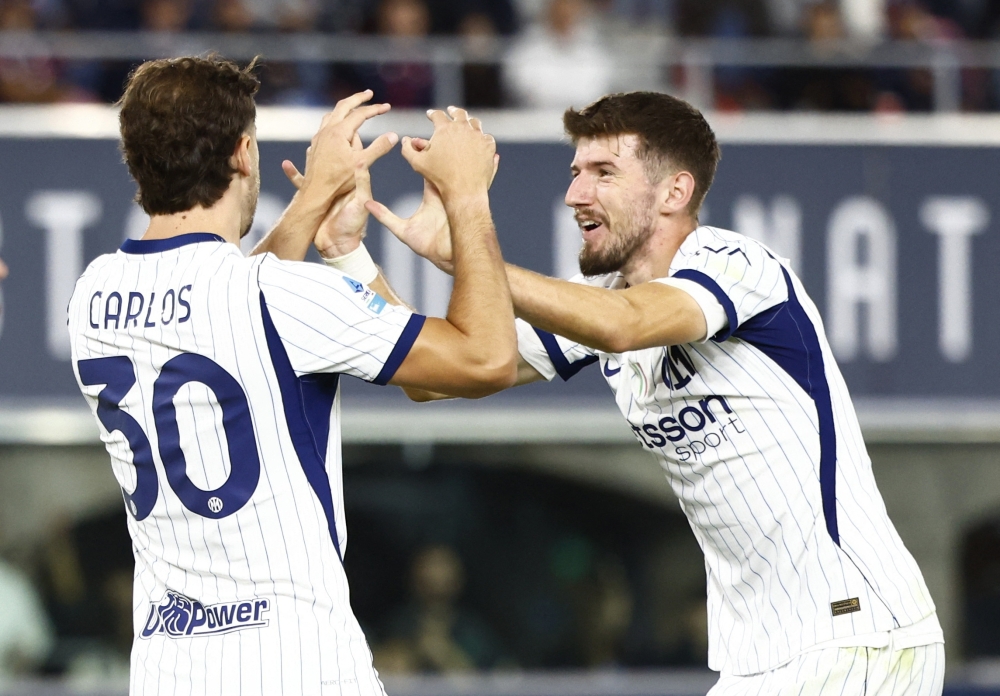 
Inter Milan's Carlos Augusto scores their second goal with Petar Sucic 
