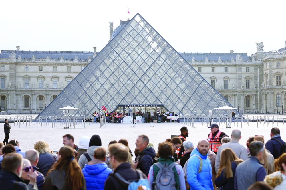 Protesters block the entrance to the Louvre Museum in Paris. — AFP
