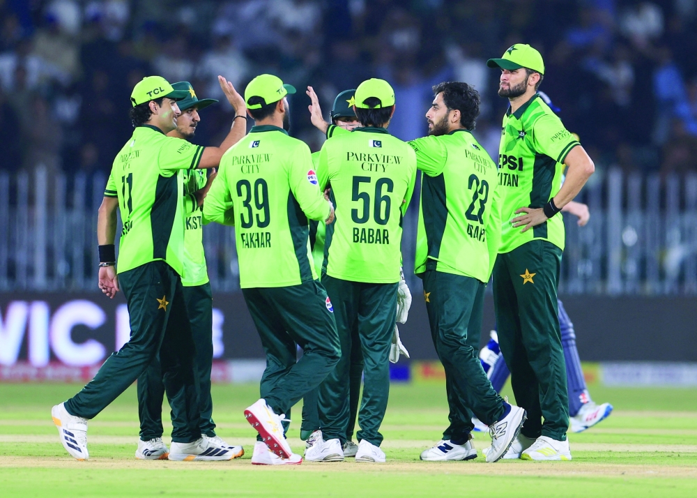 Pakistan's Arafat Minhas celebrates with teammates after taking the wicket of England's Harry Brook during the second ODI in Rawalpindi. 