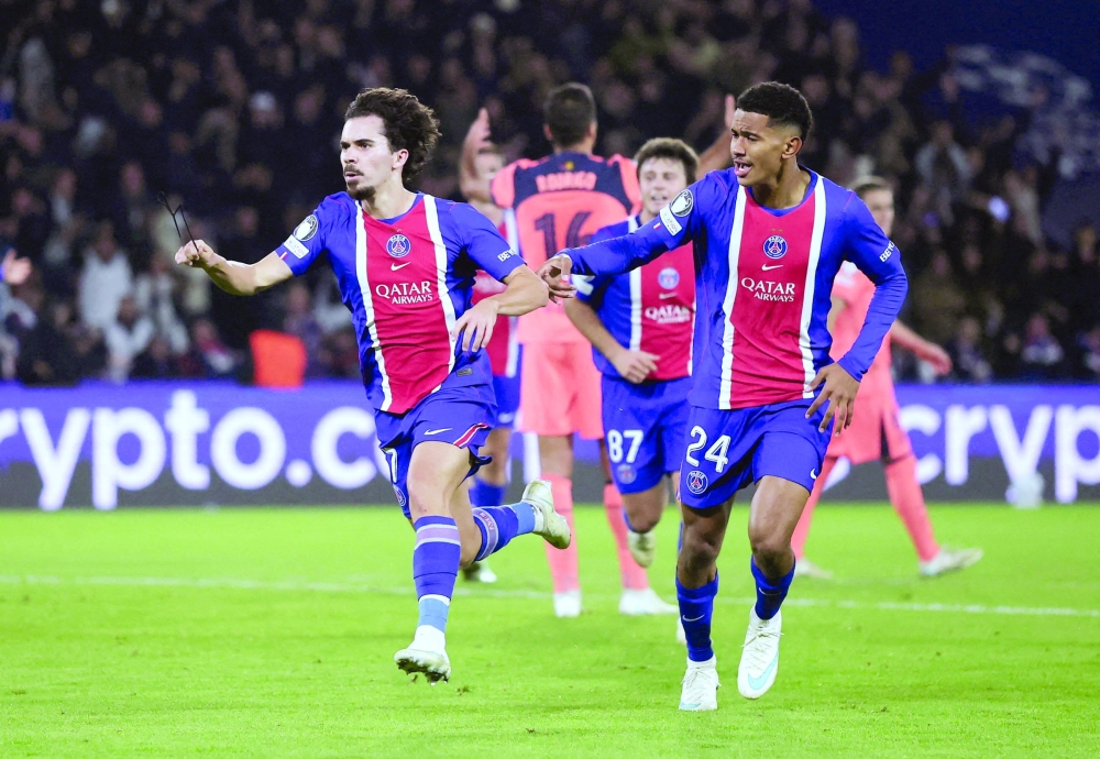 Paris St Germain's Vitinha celebrates scoring their third goal against FC Barcelona during the Uefa Champions League match in Paris. — Reuters