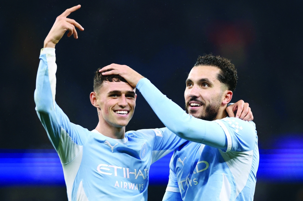 Manchester City's Rayan Cherki celebrates scoring their third goal with Phil Foden. — Reuters