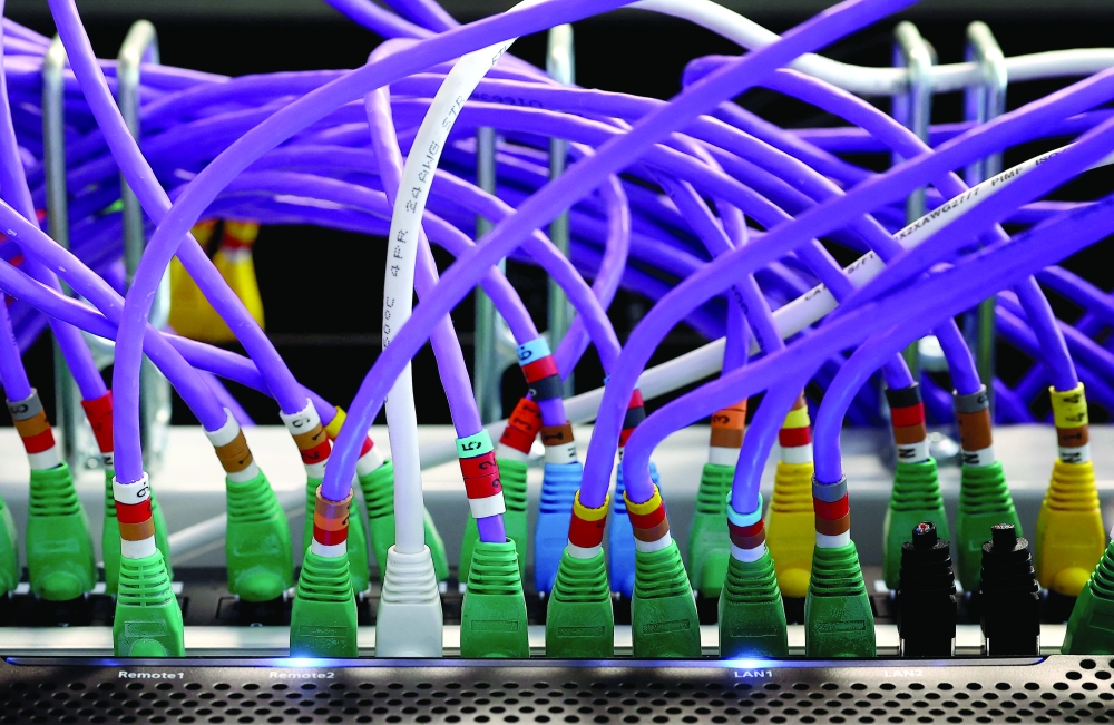 LAN network cables plugged into a computer server, as cyber agencies warn that websites may be taken offline while PHP prepares a critical fix, in Berlin. — Reuters