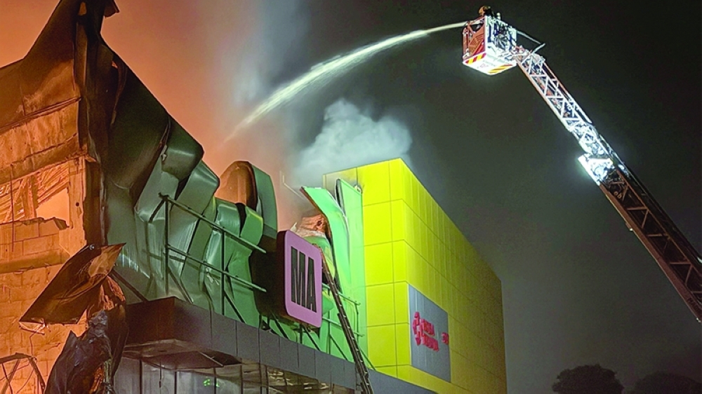 Firefighters work at the site of a shopping centre hit by a missile attack in Kyiv on Thursday. — Reuters
