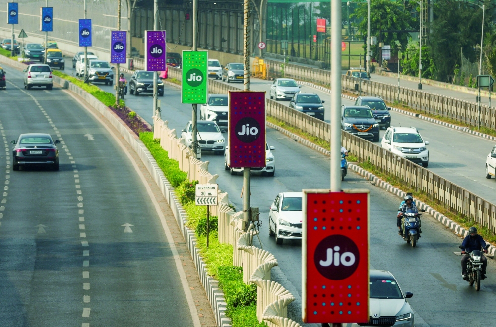 Traffic moves past Jio advertisement boards ahead of the Jio Platforms IPO listing ceremony in Mumbai. 