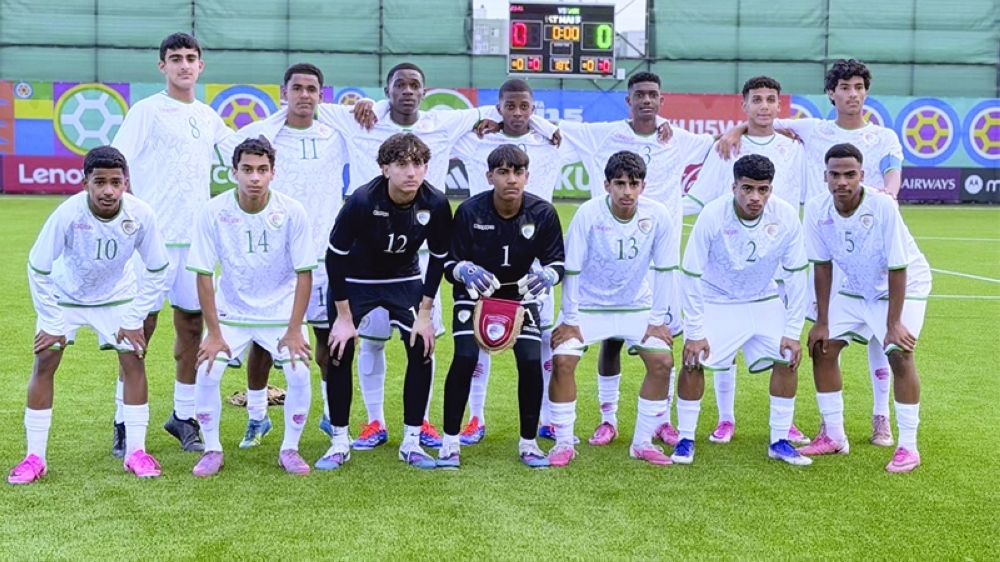 Oman players pose before the match against Suriname.