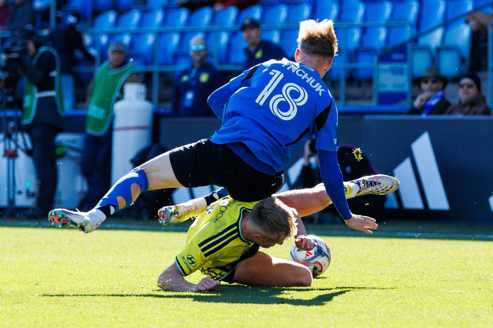 CF Montreal's Hennadii Synchuk (18) is tackled by Nashville SC's Sam Surridge (9) 