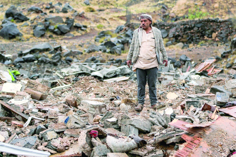 A man inspects damage at the site of an air strike, in Sanaa. — AFP