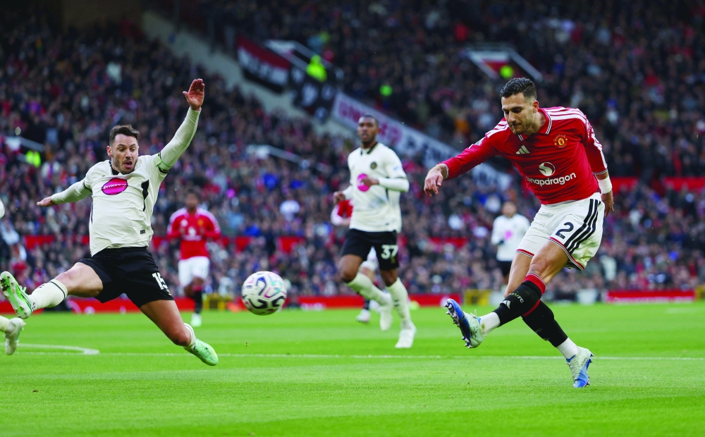 Manchester United's Diogo Dalot shoots at goal. — Reuters