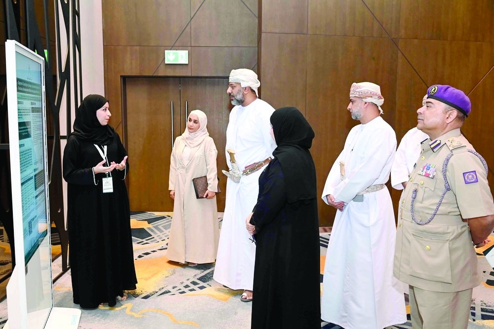 Officials view scientific posters at the University Medical City Emergency Medicine Conference 2026 at Sultan Qaboos University Hospital. — ONA