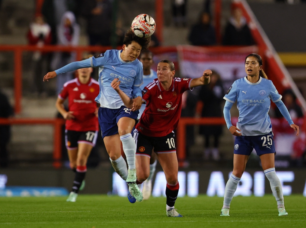  
Manchester City's Aoba Fujino in action with Manchester United's Elisabeth Terland  