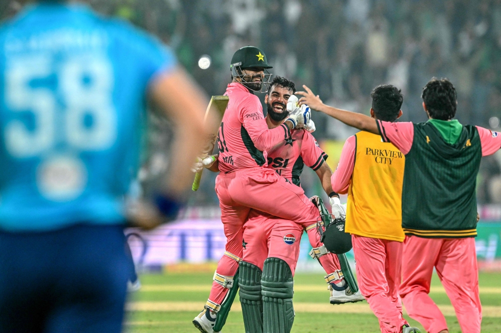 Pakistan's Shadab Khan (2L) and Haris Rauf (L) celebrate after their team's victory in the one-day international (ODI) tri-series cricket match against England  
