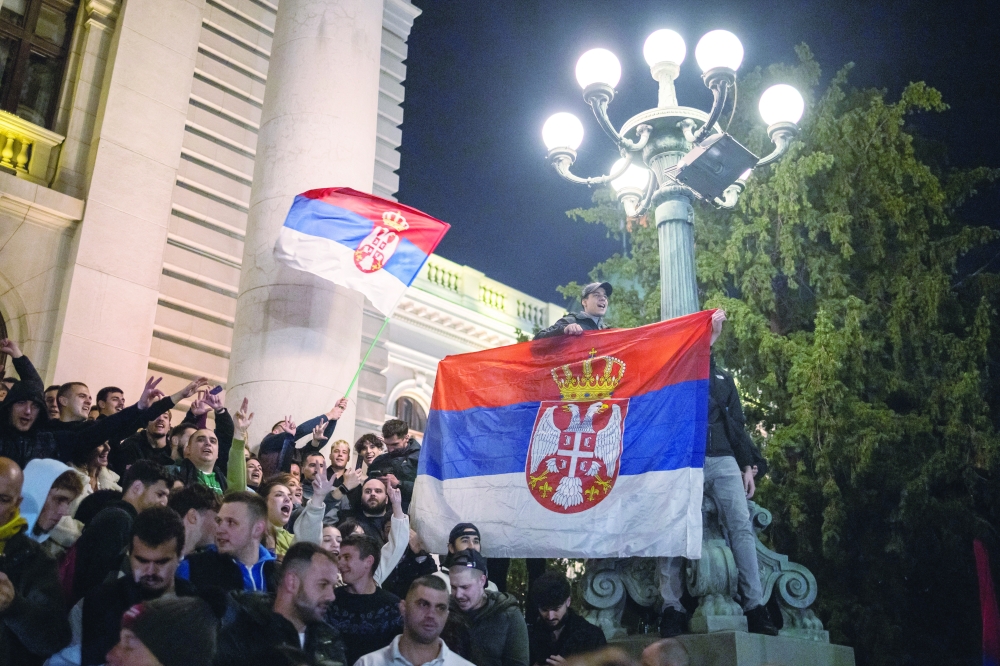 Supporters of the electoral list "Student List - Students Win" celebrate at the Parliament building in Belgrade. — Reuters 