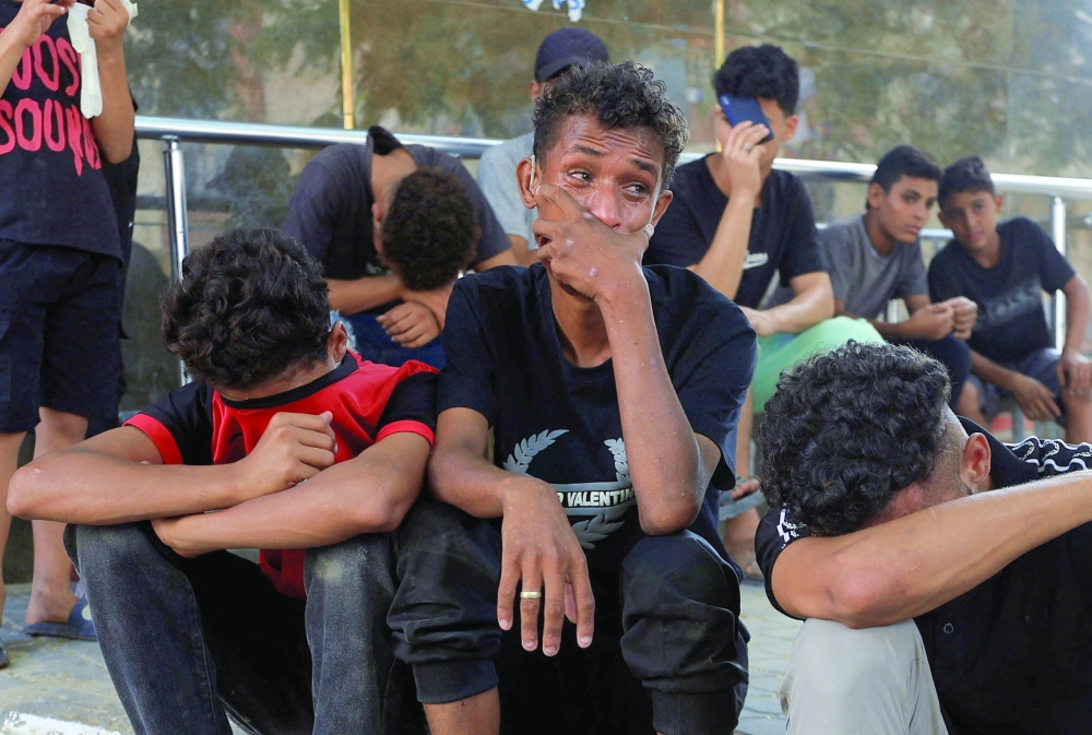 Mourners react during the funeral of three Palestinians who were killed in an Israeli strike, according to medics, at Al-Shifa Hospital in Gaza City, October 25, 2026. REUTERS/Dawoud Abu Alkas
