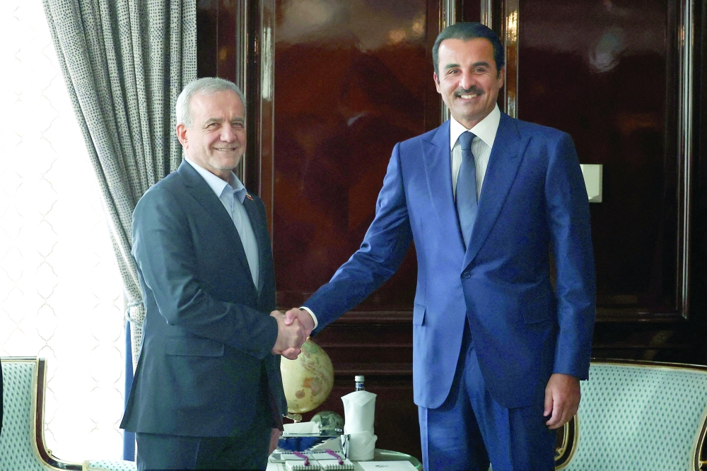 Iranian President Masoud Pezeshkian shakes hands with Qatar's Emir Sheikh Tamim bin Hamad Al Thani as they meet in Moscow. — Reuters 