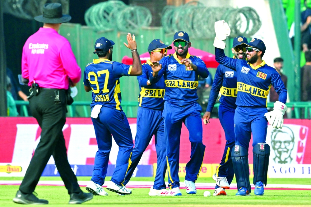 Sri Lanka's players celebrate after the dismissal of Pakistan's captain Shaheen Shah Afridi during the ODI tri-series match against Pakistan at the Gaddafi Stadium in Lahore. — AFP