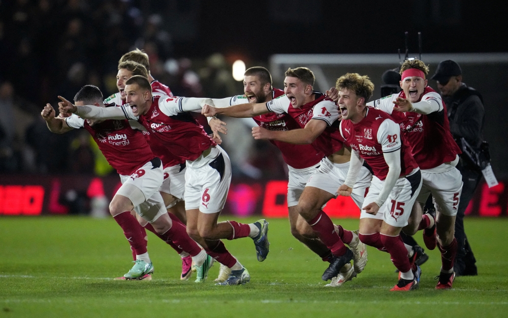  
Fleetwood Town's Rhys Bennett and teammates celebrate winning the penalty shootout  