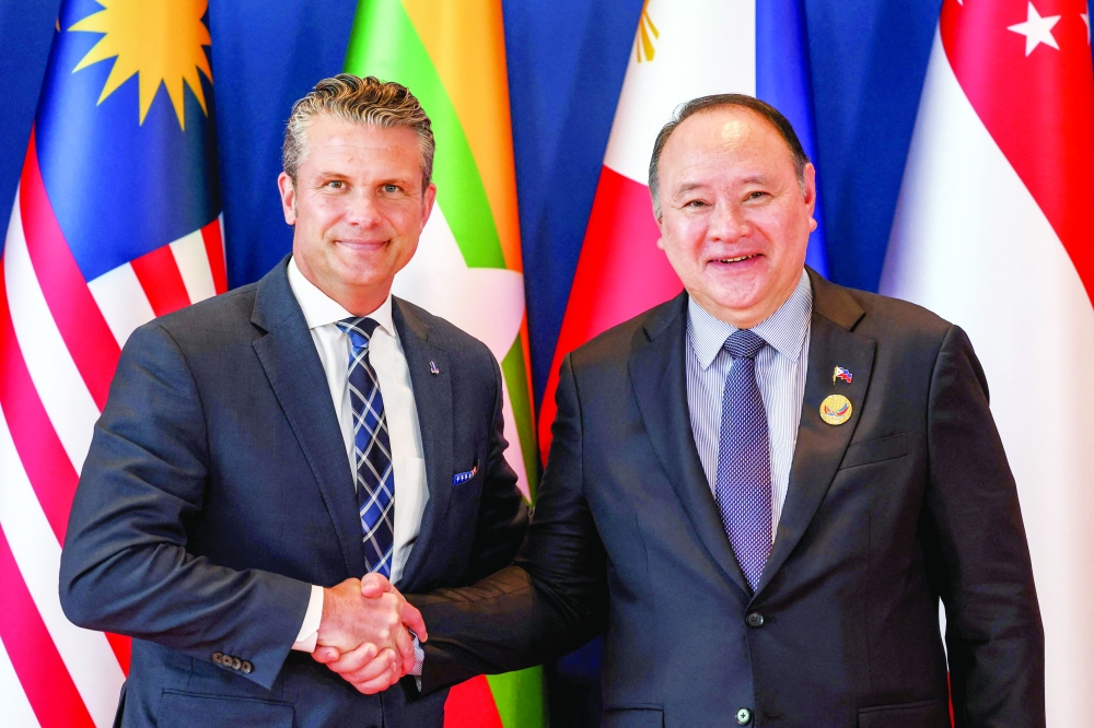 US Defence Secretary Pete Hegseth (L) is welcomed by Philippines' Defence Secretary Gilberto Teodoro (R) in Cebu