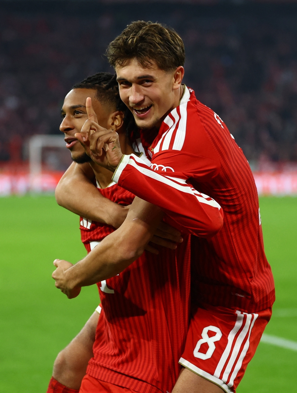  
Bayern Munich's Michael Olise celebrates scoring their third goal with Tom Bischof 