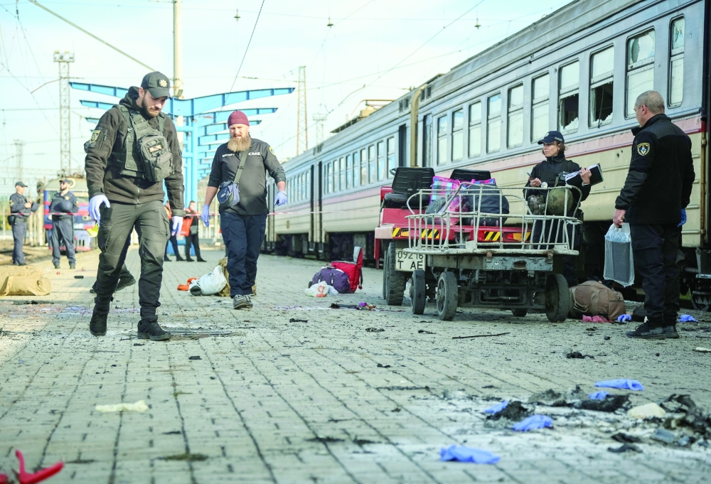Police officers at a railway station hit by a drone strike in Dnipro, Ukraine, on Thursday. — Reuters