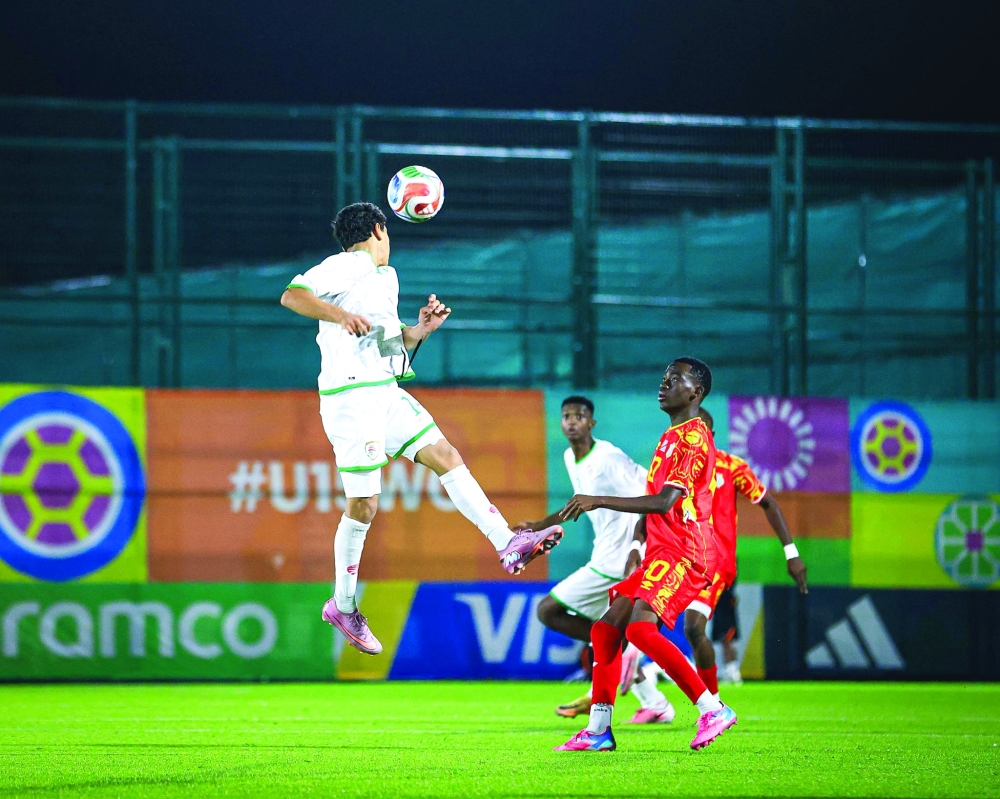 Oman and DR Congo players fight for the ball.