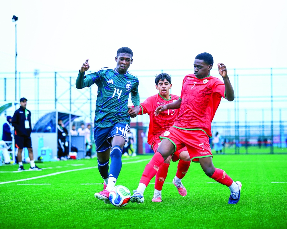 Oman and Saudi Arabia players in action.