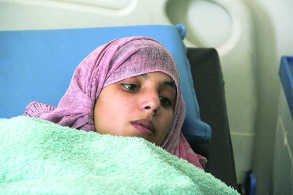 Amal al Sabri lies on a bed at a hospital in Taiz. — Reuters