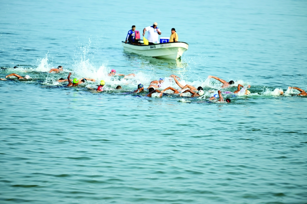 The swimmers take part in the 17th Oman Open Water Swimming Championship at Qurum Beach on Friday. — Abdulwahid al Hamadani