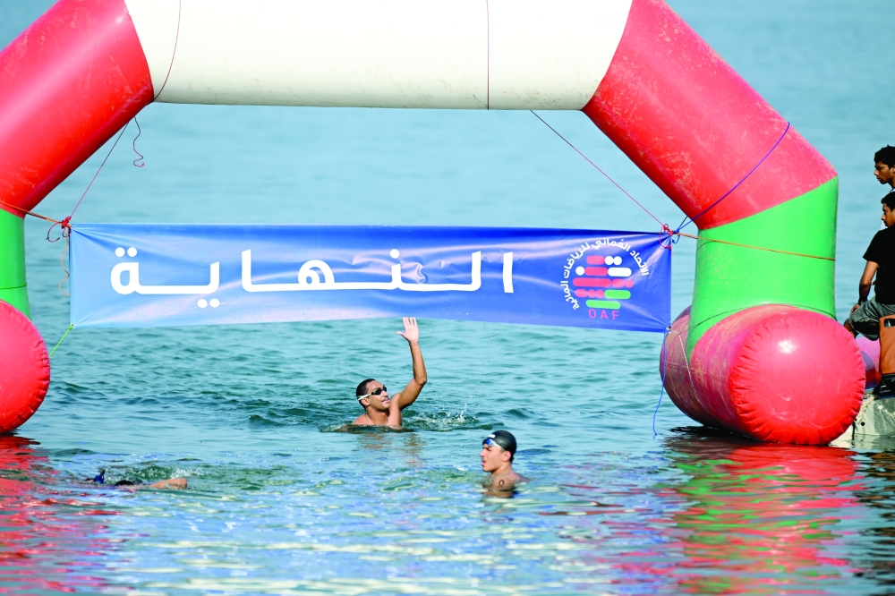 A swimmer reacts at the finishing point of the 3 km Open Water Swimming race. — Abdulwahid al Hamadani