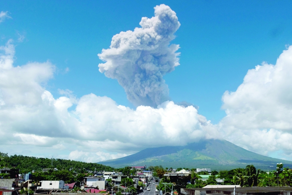 Smoke billows into the sky as Mayon volcano erupts as seen from Legaspi City, Albay province, south of Manila. 