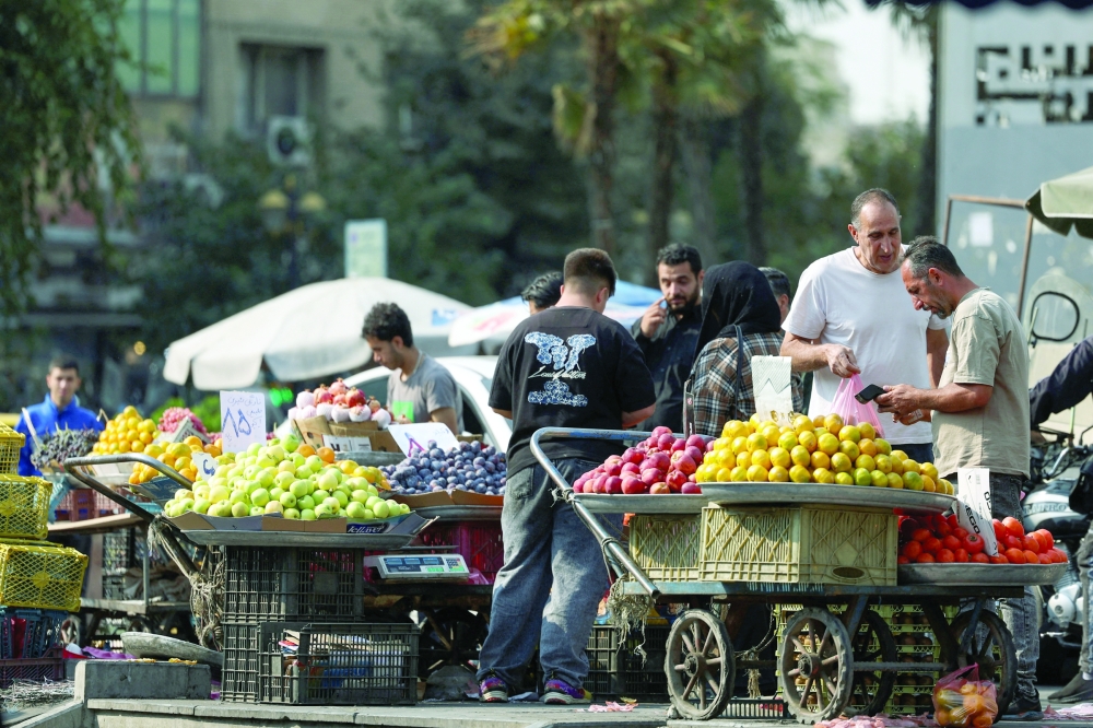 People shop at a local market in Tehran, Iran. —AFP