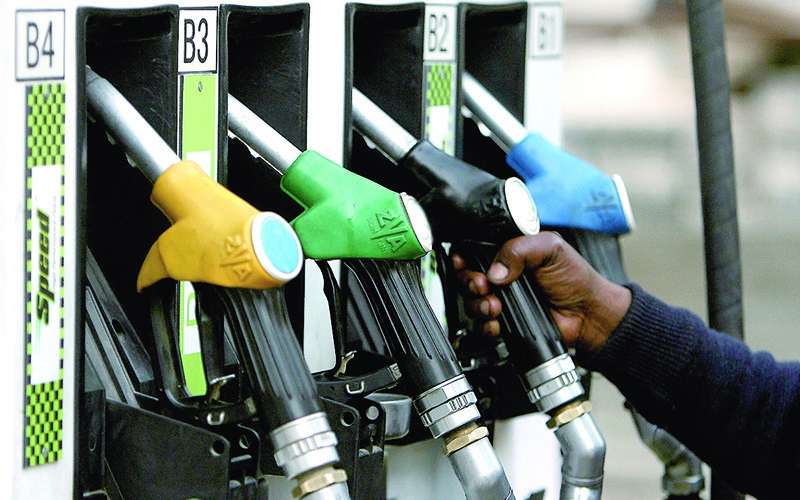 An Indian petrol pump attendant prepares