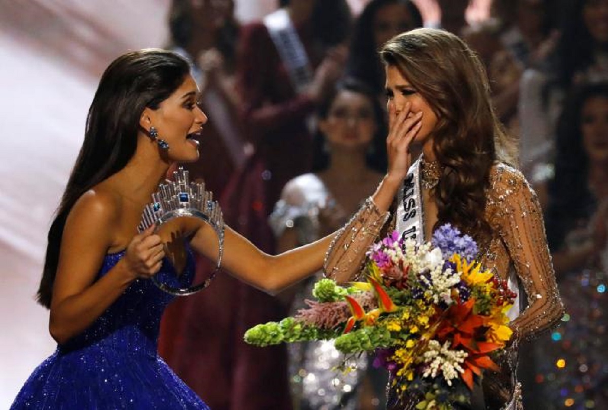 Pia Wurtzbach holds the crown as she rushes towards Miss France Iris Mittenaere after the latter was  declared winner in the 65th Miss Universe beauty pageant at the Mall of Asia Arena, in Pasay