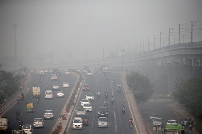 Traffic drives through smog in Delhi