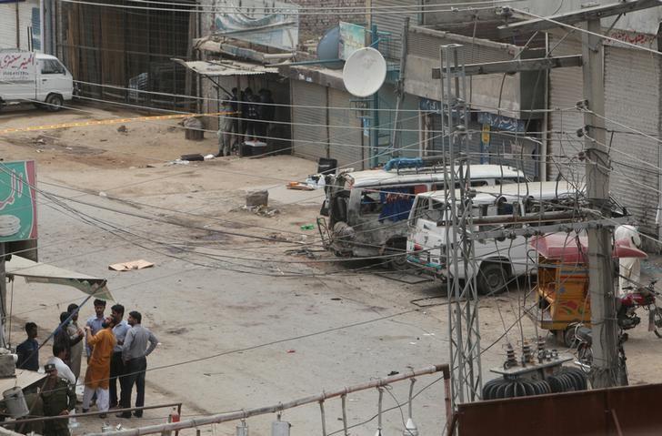 Security officials gather near the site of an explosion in Lahore