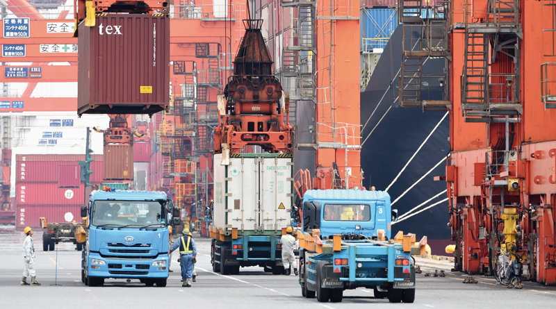 Containers-are-loaded-onto-trucks-from-an-international-freighter-at-Tokyo-port.-AFP