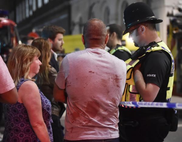People speak with police officers after an incident near London Bridge in London