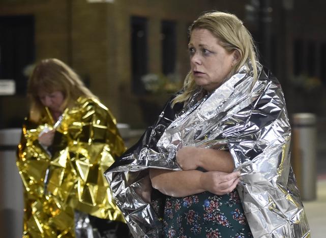 People leave the area wearing foil blankets after an incident near London Bridge in London