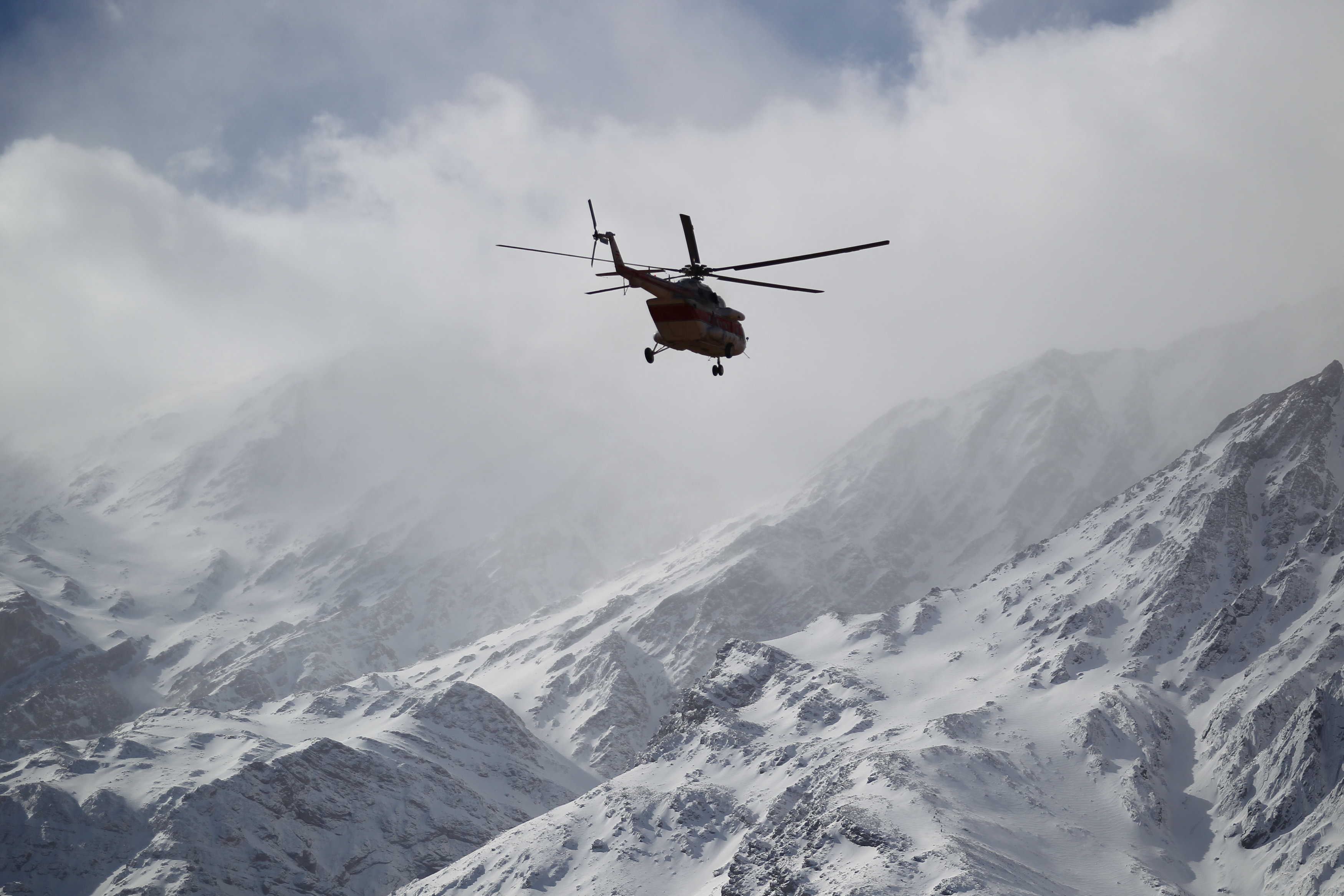 Emergency and rescue helicopter searches for the plane that crashed in a mountainous area of central Iran