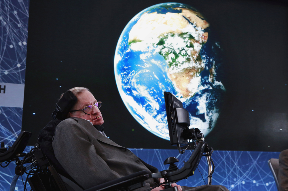 FILE PHOTO: Physicist Stephen Hawking sits on stage during an announcement of the Breakthrough Starshot initiative with investor Yuri Milner in New York